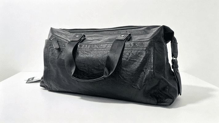 Black travel duffle bag with greyboard insert for bag shape support, greyboard used inside luggage