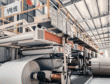 Composite greyboard manufacturing facility showing multi-base production system, quality control testing of paperboard thickness and rigidity, and industrial packaging materials for gift box applications in a modern B2B factory environment.Select 62 more words to run Humanizer.