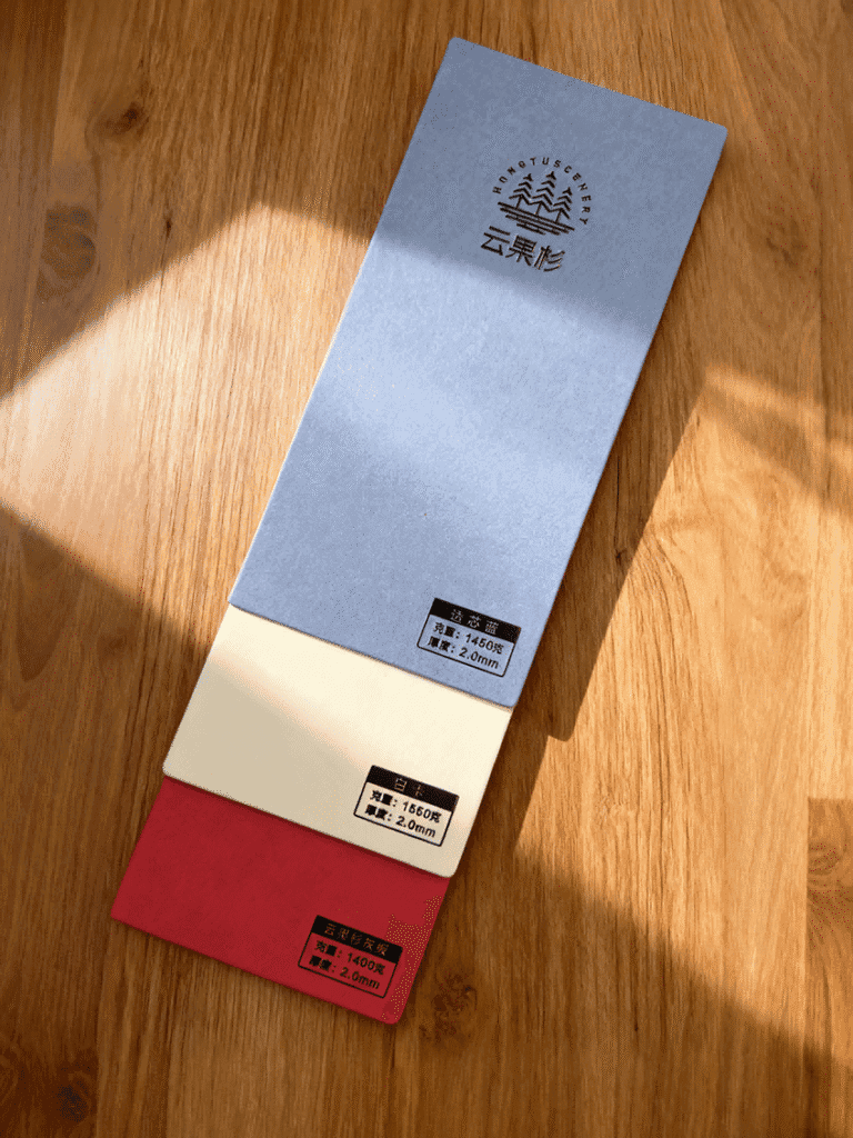 Cloud Cedar paperboard with smooth, lightweight fiber structure.