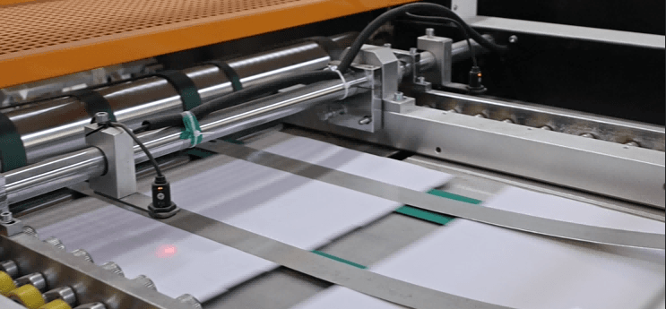 Stack of white coated board sheets used as base material for laminated greyboard in luxury gift box packaging