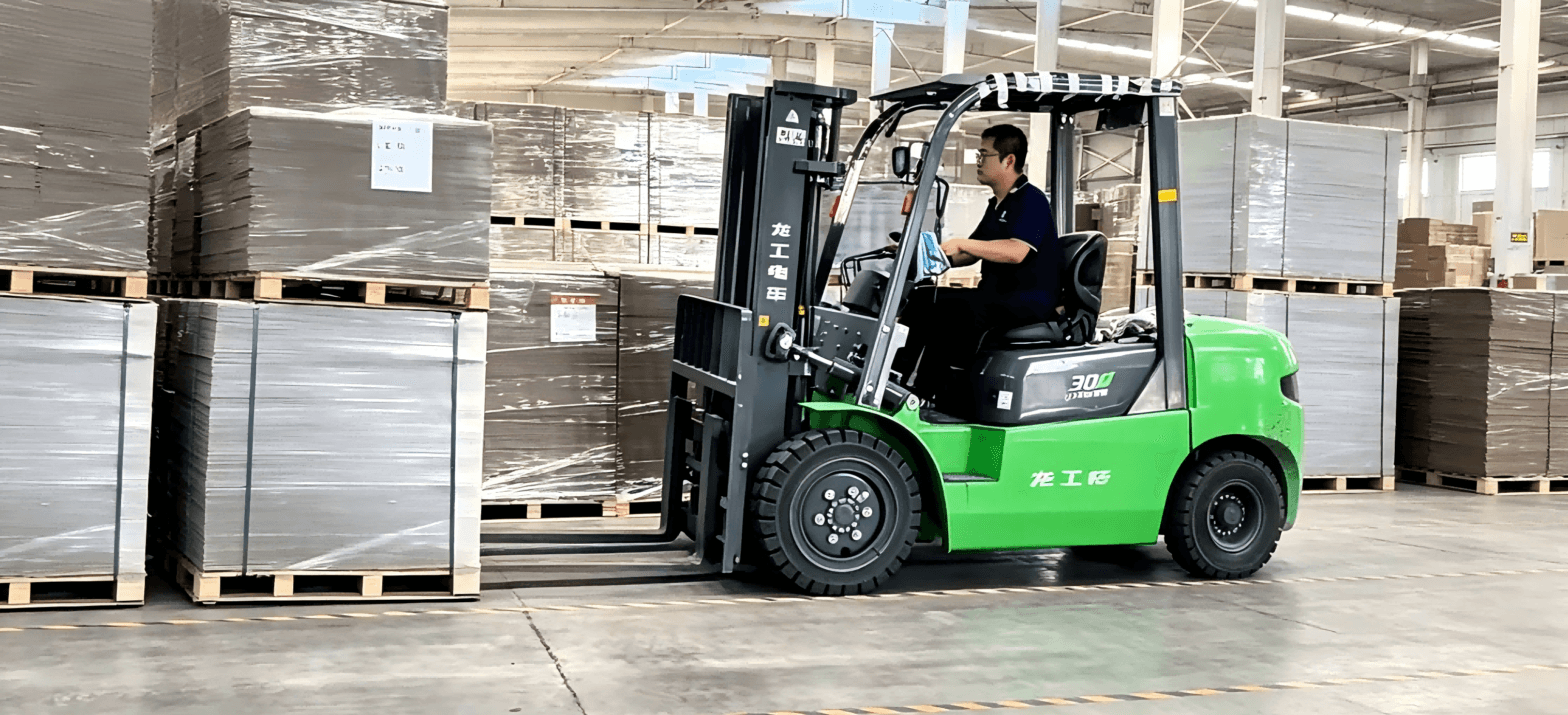 Chinese grey board supplier warehouse, forklift handling stacked grey cardboard sheets for fast delivery, industrial packaging material production facility