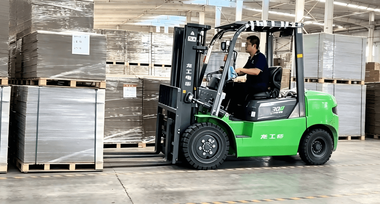 Chinese grey board supplier warehouse, forklift handling stacked grey cardboard sheets for fast delivery, industrial packaging material production facility