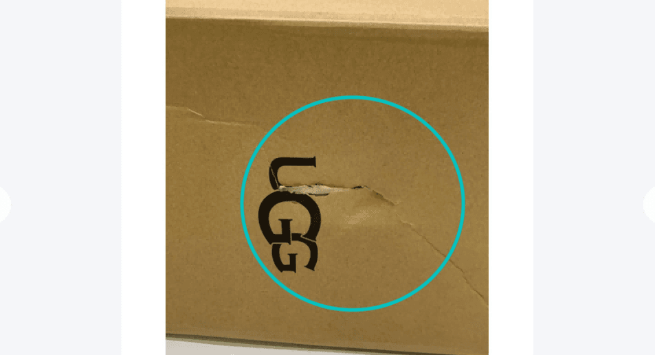 Damaged rigid gift box with crushed corners and deformation during shipping in logistics container