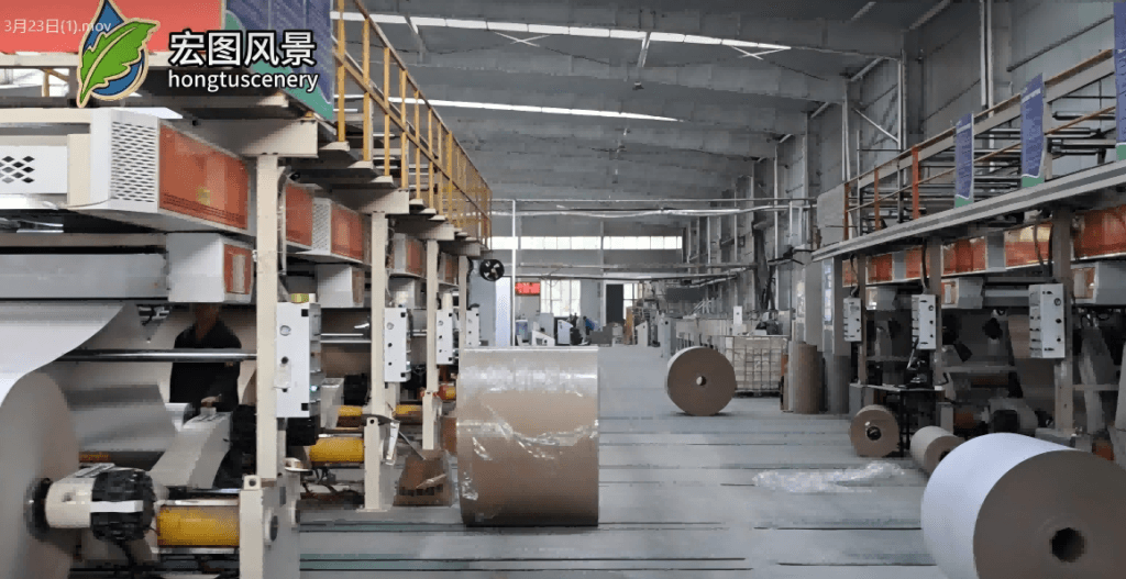 Advanced production line of composite grey board at Hongtu Scenery factory, showcasing our professional packaging material manufacturing capability.