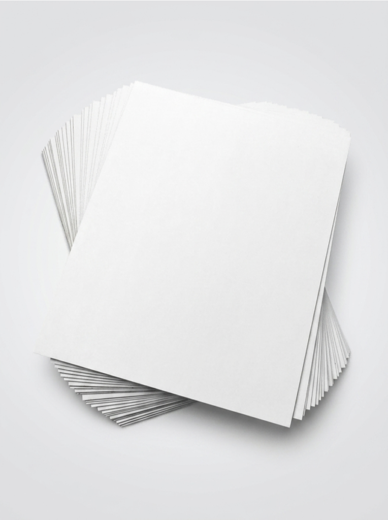 White Lined Chipboard (WLC) sheets stacked in different cut sizes for packaging paperboard applications