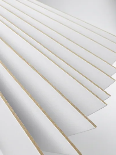 Recycled grey back paperboard with layered WLC board structure for folding cartons