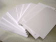 Cover image: Solid bleached board (SBS paperboard) – a stack of bright white paperboard sheets with clean cut edges, representing premium packaging material