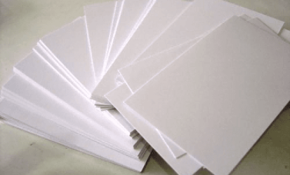 Cover image: Solid bleached board (SBS paperboard) – a stack of bright white paperboard sheets with clean cut edges, representing premium packaging material