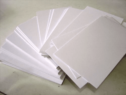 Cover image: Solid bleached board (SBS paperboard) – a stack of bright white paperboard sheets with clean cut edges, representing premium packaging material