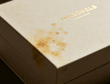 White rigid gift box with yellow stains caused by grey board quality problems after long-term storage
