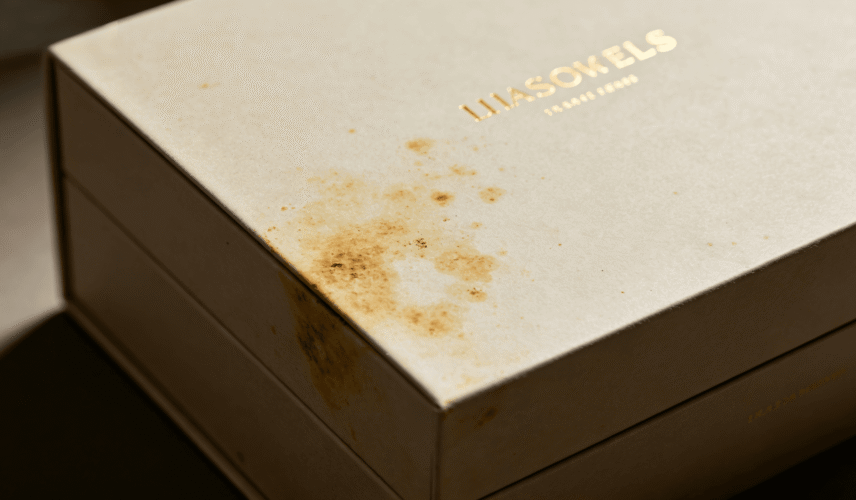 White rigid gift box with yellow stains caused by grey board quality problems after long-term storage