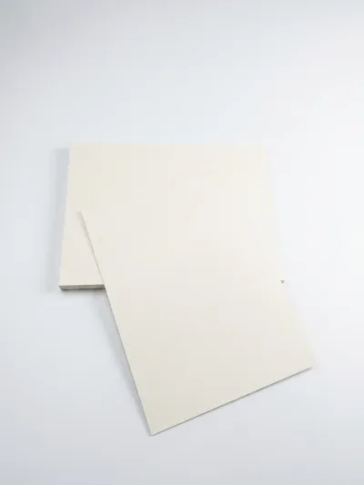 Premium SBS Paperboard sheets stacked in warehouse for luxury packaging and printing applications