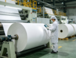 Modern Chinese SBS paperboard manufacturing plant, large paper rolls production line with export shipping containers, global paper supply chain